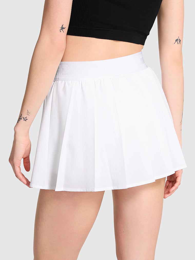 PINK Tech Stretch Pleated Tennis Skort, White/Ivory, onModelBack, 2 of 4 Sofia is 5'10" or 178cm and wears Small
