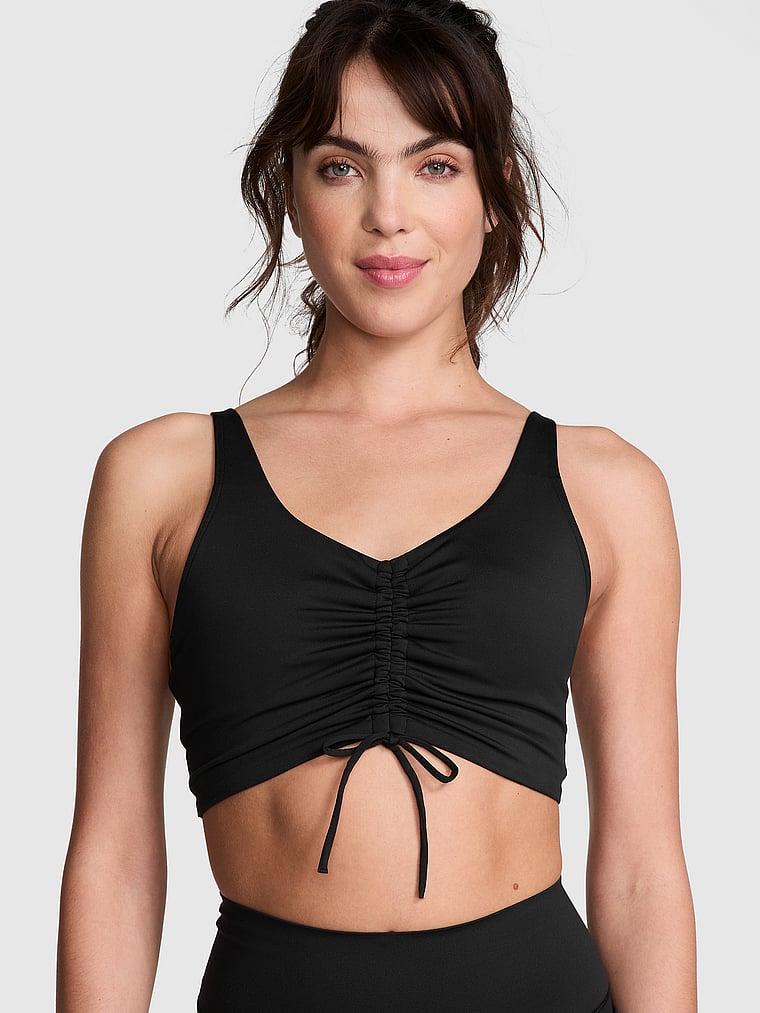 PINK Relay Ruched Plunge Sports Bra, Pure Black, onModelFront, 1 of 4 Scarlett is 5'11" or 180cm and wears 34B or Small